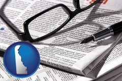 de map icon and a newspaper, with reading glasses and fountain pen