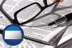 kansas map icon and a newspaper, with reading glasses and fountain pen