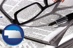 ne map icon and a newspaper, with reading glasses and fountain pen