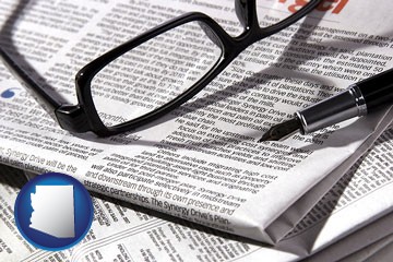 a newspaper, with reading glasses and fountain pen - with Arizona icon