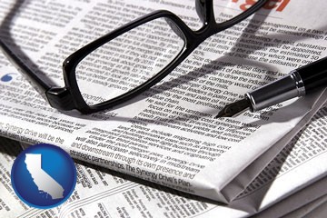a newspaper, with reading glasses and fountain pen - with California icon