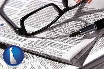 a newspaper, with reading glasses and fountain pen - with Delaware icon