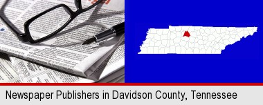 a newspaper, with reading glasses and fountain pen; Davidson County highlighted in red on a map