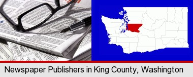 a newspaper, with reading glasses and fountain pen; King County highlighted in red on a map