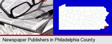 a newspaper, with reading glasses and fountain pen; Philadelphia County highlighted in red on a map
