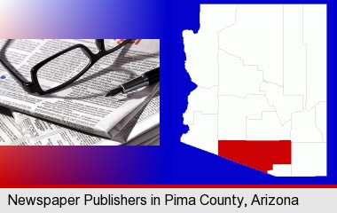 a newspaper, with reading glasses and fountain pen; Pima County highlighted in red on a map