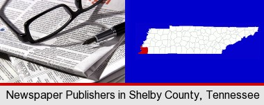 a newspaper, with reading glasses and fountain pen; Shelby County highlighted in red on a map