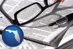 florida map icon and a newspaper, with reading glasses and fountain pen