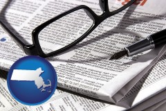 massachusetts map icon and a newspaper, with reading glasses and fountain pen