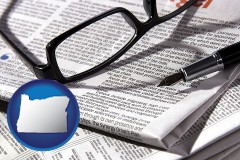 oregon map icon and a newspaper, with reading glasses and fountain pen